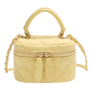 Quilted yellow mini square crossbody bag with gold chain strap and top handle on white background