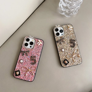 Detail of glitter iPhone case with 3D rhinestone bow and pearl charms for a luxury look