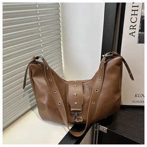 Detail of brown PU leather hobo bag featuring star studs and metallic buckle strap