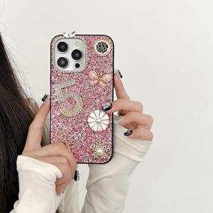 Pink glitter iPhone case featuring 3D butterfly, pearl charms, and rhinestone number 5