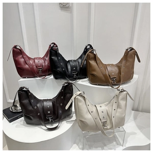 Five assorted hobo bags in various colors featuring silver star studs and metal eyelets