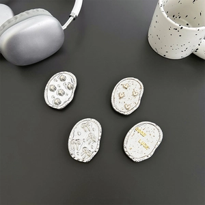 Chic silver electroplated heart and star phone sockets on a minimalist desktop