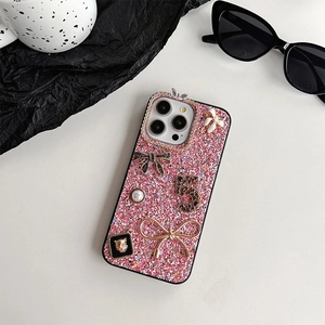 Close-up of glitter iPhone case with 3D pearls, metal bows and rhinestone embellishments