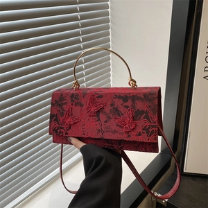 Elegant red square handbag with butterfly embroidery and a gold semi-circle handle