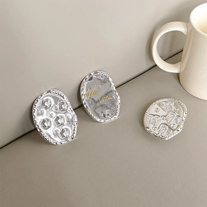 Close-up of silver-plated heart and star phone grips with Good Luck engraving
