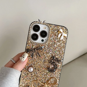 Macro detail of iPhone case with glitter finish, 3D bows, rhinestones and pearls