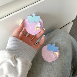 Close-up of pink and purple acrylic strawberry phone grips with cute 3D bow details