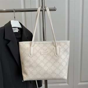 Elegant cream floral embossed tote bag with silver logo tag for women's fashion