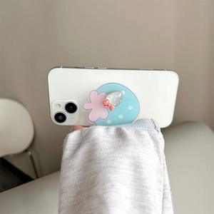 Cute strawberry phone grip stand on a white smartphone held by a girl in hand