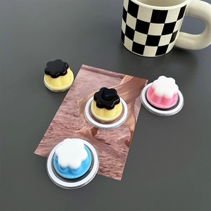 Magnetic flower griptok stand for MagSafe with cream jelly finish on a gray desk