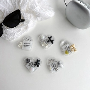 Flat lay of heart-shaped glitter phone grips with resin dog and bow designs
