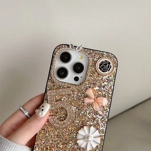 Macro detail of glitter iPhone case with rhinestone number 5 and butterfly charms