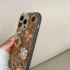 Close-up of luxury gold glitter phone case with rhinestone 5 and butterfly charms