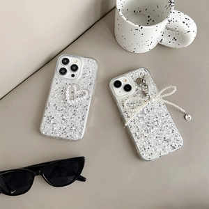 Detail of iPhone case with silver sequins, pearl heart design and bow pendant charm