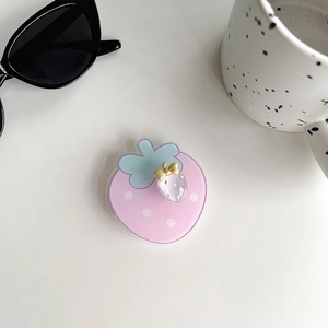 Detailed top view of pink strawberry phone socket with cute bow and acrylic charm