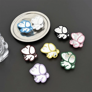 Mirror-finish cartoon dog phone grips in multiple colors with pearl accents on grey surface