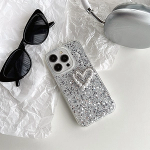 Close-up of glitter iPhone case with white faux pearl heart and silver sequins