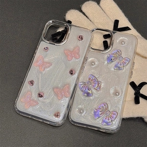 Detail of glitter iPhone case featuring 3D pink butterfly, pearls, and rhinestone bow