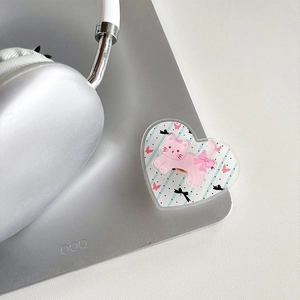 Detail of a heart-shaped acrylic phone grip with a cute pink cat and polka dot pattern