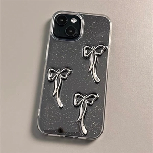 Detailed view of dark grey transparent glitter iPhone case with 3D silver metal bows