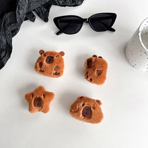 Plush brown capybara hair clips in round and star shapes with embroidery details