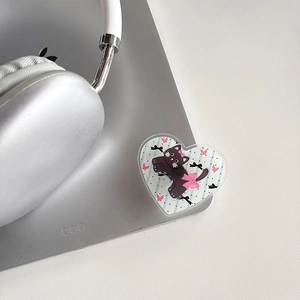 Close-up of heart-shaped cat phone grip holder on silver laptop with cute bow design