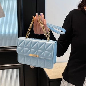 Light blue quilted leather handbag with gold chain handle and metal twist lock