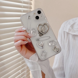 Macro detail of clear iPhone case with silver heart charms and metal pull tab décor
