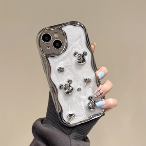 Detail of silver plated wavy phone case with 3D bear and heart rhinestone decorations