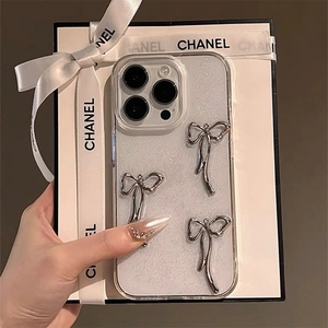 Detail shot of glitter iPhone case featuring three silver metallic 3D bowknot ornaments