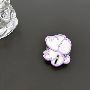 Detail of cute puppy phone grip with reflective mirror surface and pearl accent decoration