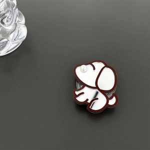 Detail of mirror-finish dog phone socket with white pearl nose on dark gray surface