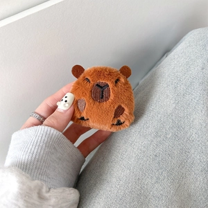 Detail of plush brown capybara phone grip with fine embroidery and soft texture finish