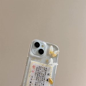 Macro detail of clear iPhone case with gold foil, 3D butterflies and lucky turtle charm
