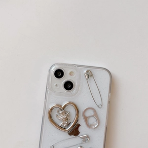 Macro shot of glittery clear iPhone case featuring silver angel heart and metal pin