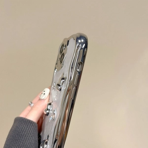 Close-up of silver liquid metal phone case with 3D chrome hearts and precise cutouts