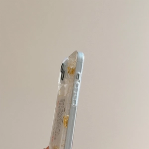 Close-up of clear phone case with gold foil details and elegant calligraphy art