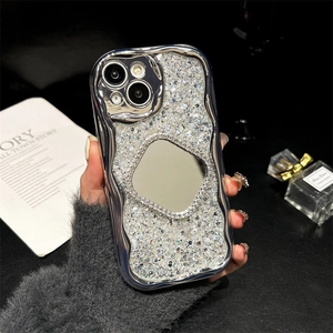Detail of silver wavy phone case featuring a sparkling rhinestone back and small makeup mirror