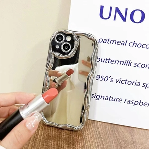 Close-up of wavy silver mirror phone case reflecting a lipstick for makeup touch-ups