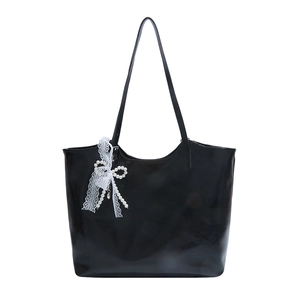Large black glossy tote bag with white lace bow and pearl pendant decoration