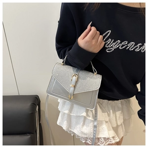 Modern crossbody bag with glitter flap and silver faux leather shown on model