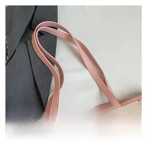 Close-up of pink leather handles and cute bear print on white canvas tote bag