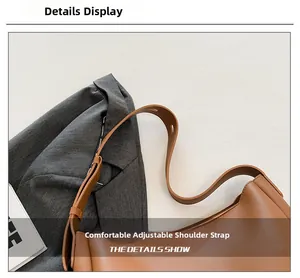 Detail of adjustable shoulder strap with metal buckle on brown leather tote bag