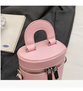 Close-up of pink mini box bag showing silver double zipper and stitch detail