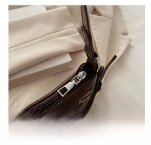 Detail of premium leopard print shoulder bag featuring a smooth silver metal zipper closure