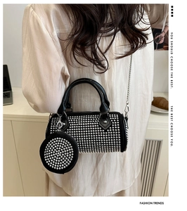 Detail of black rhinestone boston bag with detachable coin purse and metal chain strap