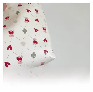 Detailed view of the premium fabric featuring printed pink bears and red hearts on the tote
