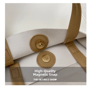 Detailed macro view of the golden magnetic buckle and precise stitching on the leather tote bag