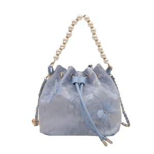 Blue lace floral bucket bag with pearl handle and mesh butterfly detail in summer style