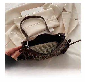 Detailed interior view of leopard print shoulder bag showing space for a smartphone